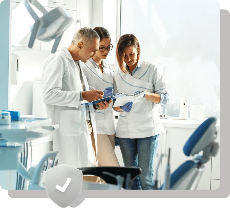Dental professionals discussing patient notes.