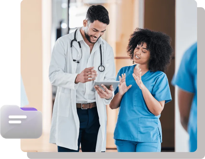 Doctor and nurse collaborating over a tablet in a hospital.