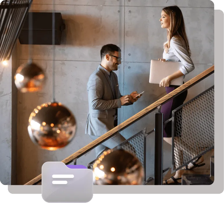 Two professionals walking upstairs in a modern office setting.