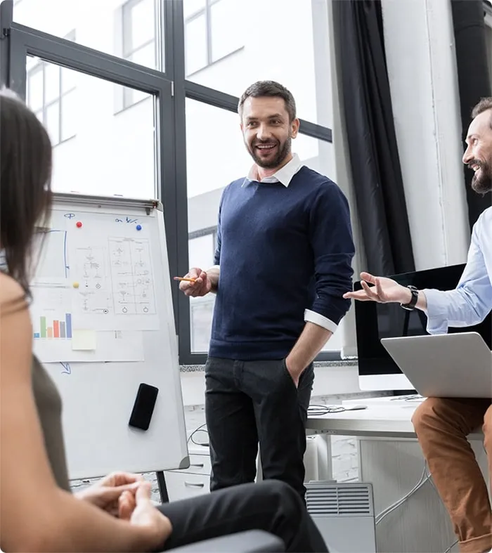 Team leader explaining a business strategy at a whiteboard