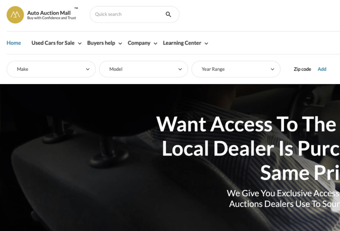 An AutoAuctionMall.com car dealership website with a car in the background.