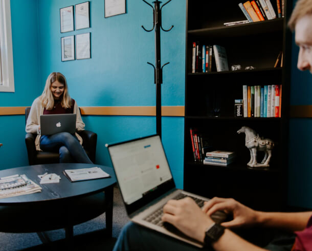 A team of individuals working on laptops in an office, focusing on technical SEO services.