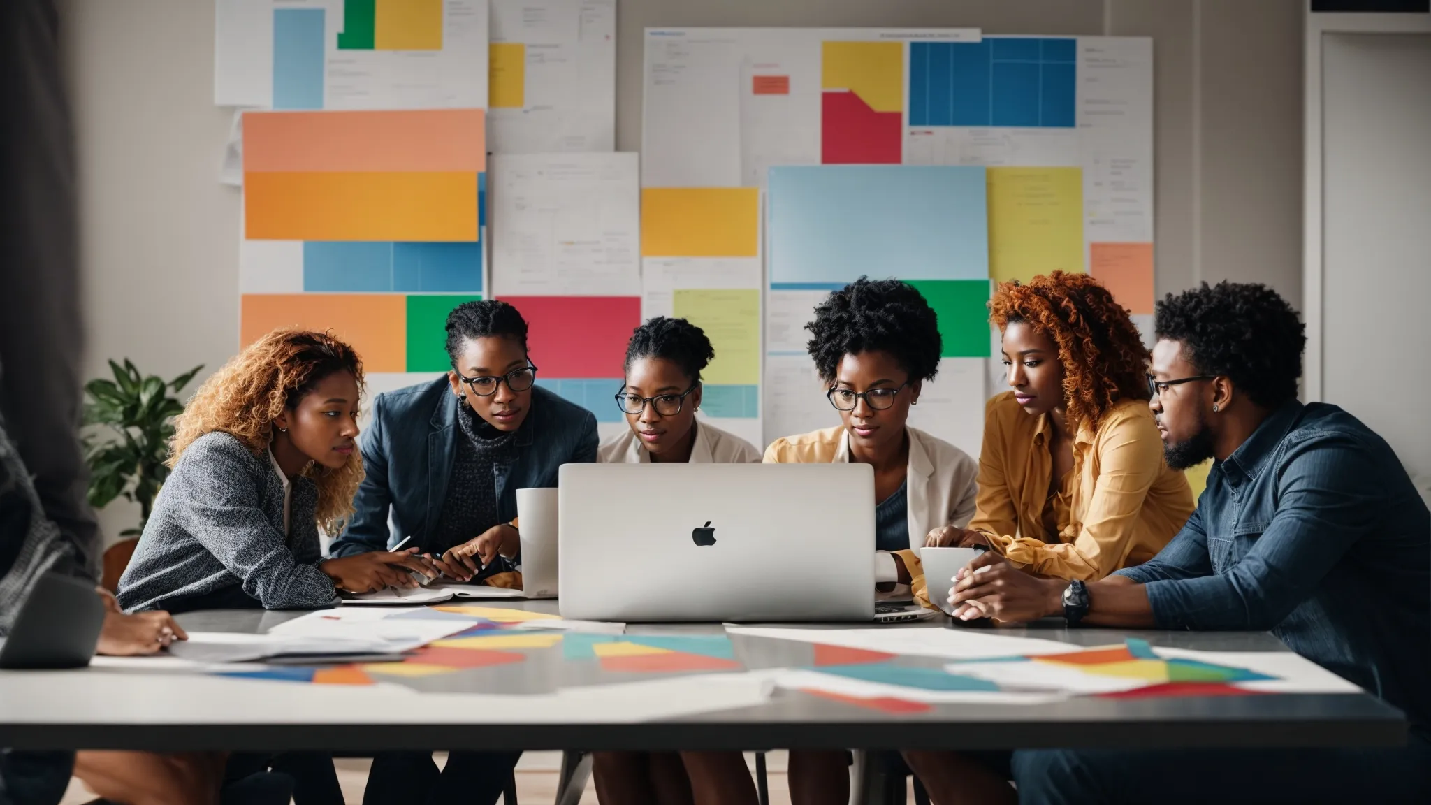 a diverse group of professionals engaging in a lively brainstorming session around a laptop displaying colorful graphs and strategy documents.