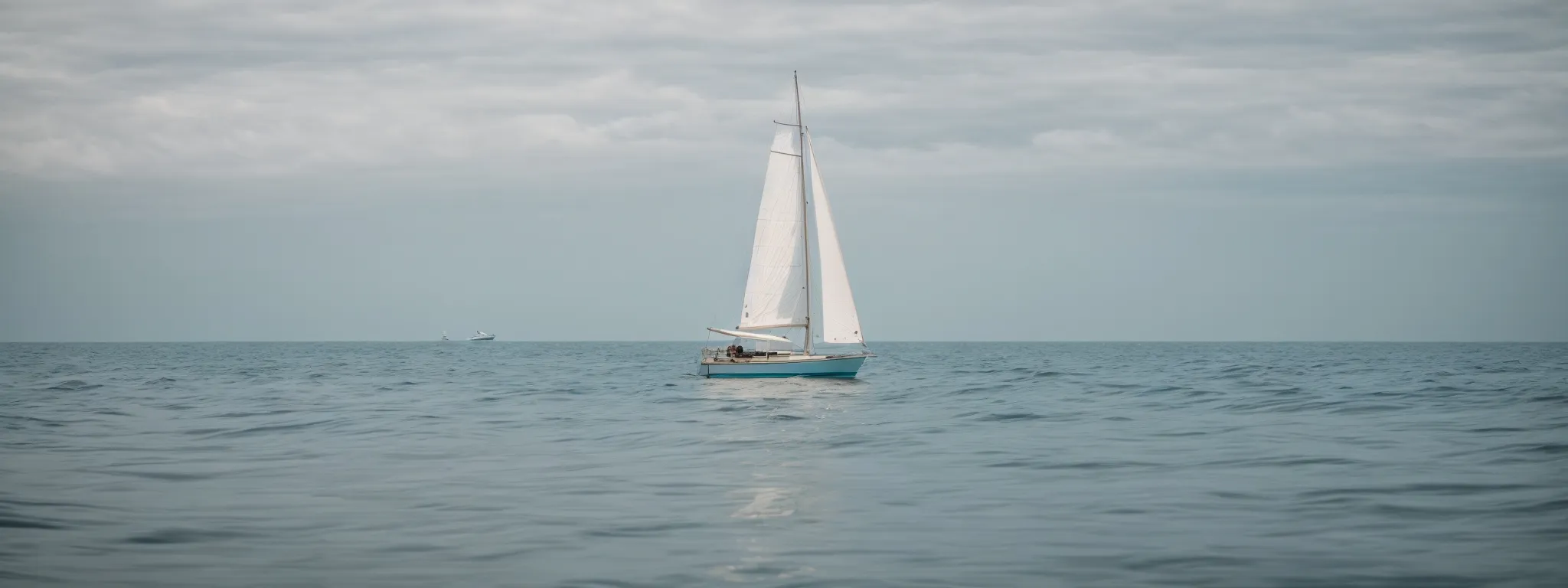 a small sailboat gliding through a calm sea, avoiding visible underwater obstacles.