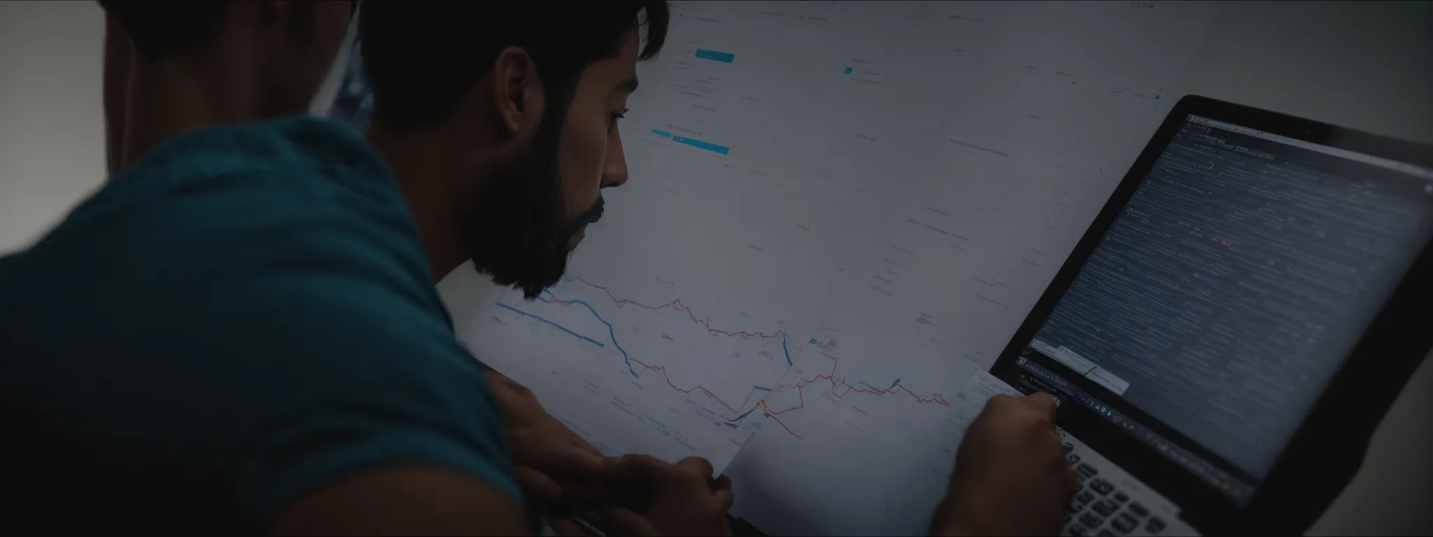 a digital marketing strategist intently examines a graph-laden computer screen, mapping out an seo campaign.