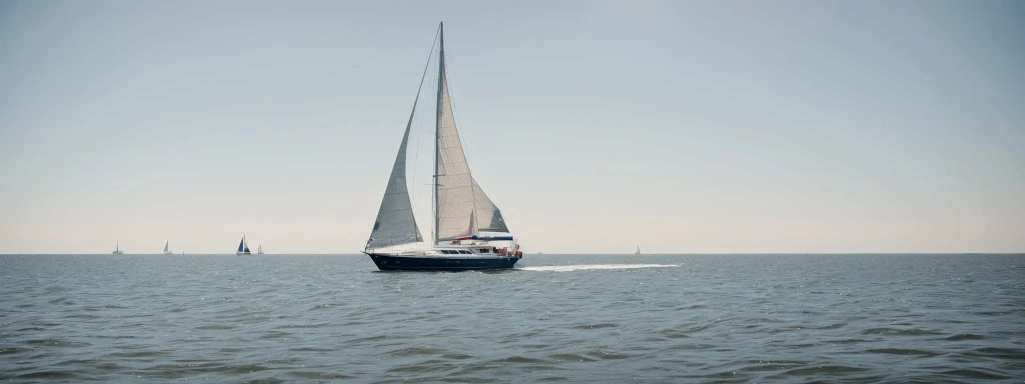a sailboat navigates the calm chesapeake bay under a clear sky, symbolizing maryland's maritime businesses' journey through the digital market landscape.