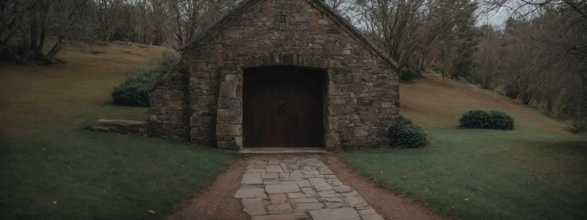 a church with an open door and a visible pathway leading to it set against a serene backdrop.