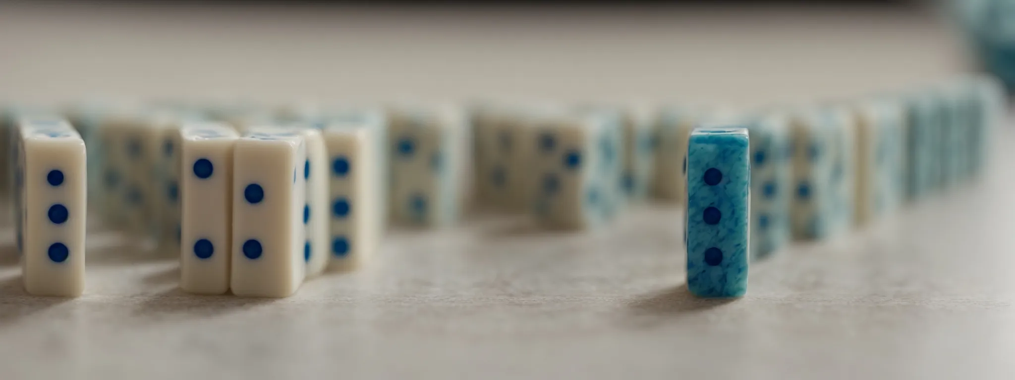 a row of dominos standing meticulously aligned, poised to illustrate the impact of initial strategic moves on long-term success.
