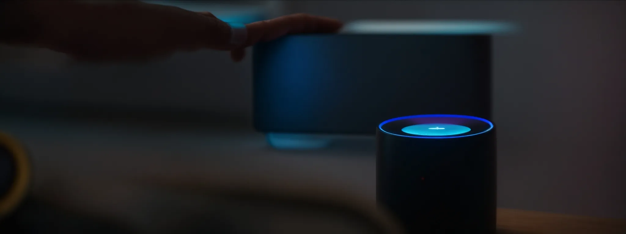 a person speaks into a smart speaker, as the device's lights glow in response.