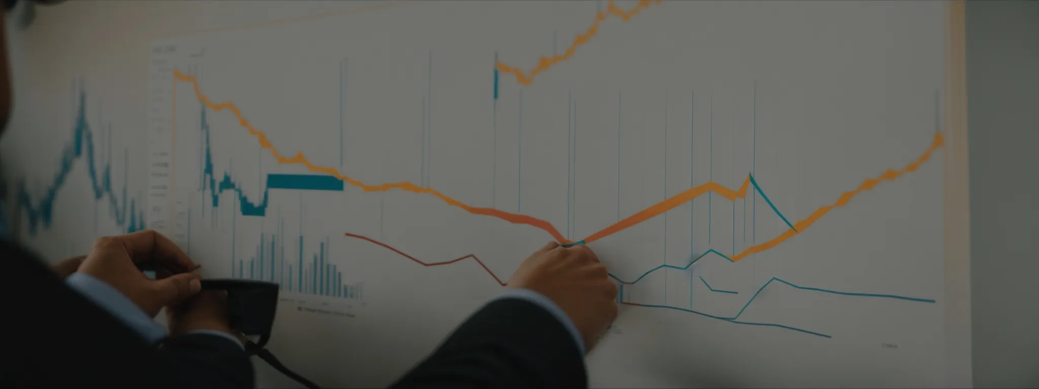 a business professional analyzing a graph that reflects investment and return over time.