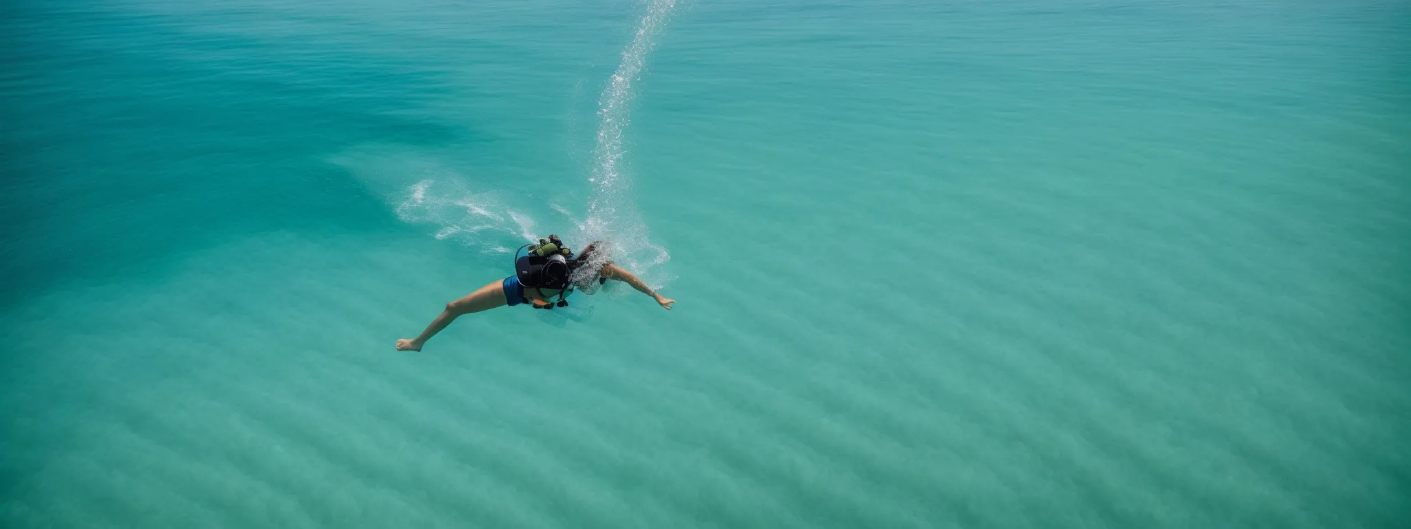 a person diving into a clear ocean, symbolizing the immersive journey into content marketing strategies.