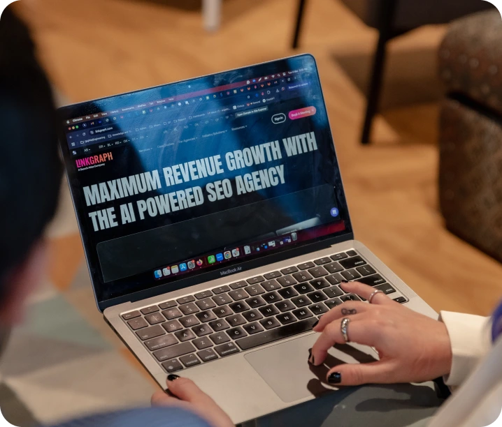 A person uses a laptop displaying a website with the headline "Maximum revenue growth with the AI powered SEO agency," highlighting the advantages of advanced Enterprise SEO Software.